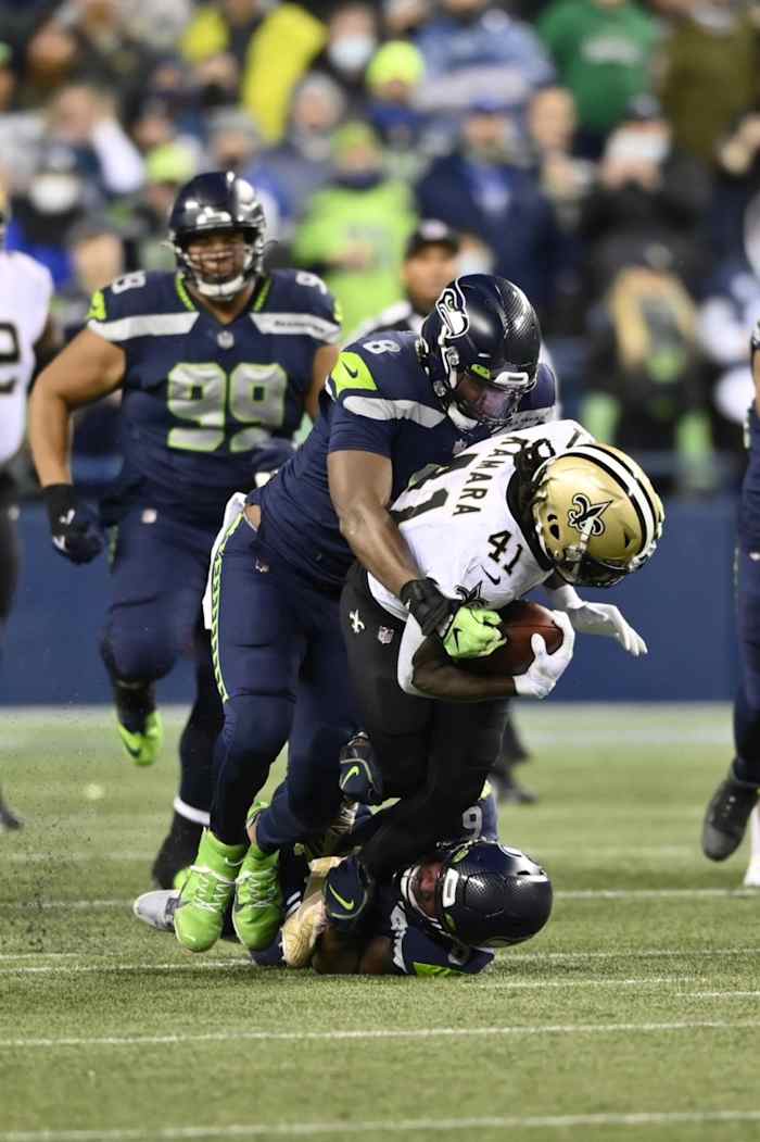 Former Seattle Seahawks defensive end Carlos Dunlap (8) and safety Quandre Diggs (6) tackle New Orleans Saints running back Alvin Kamara (41). Mandatory Credit: Steven Bisig-USA TODAY Sports
